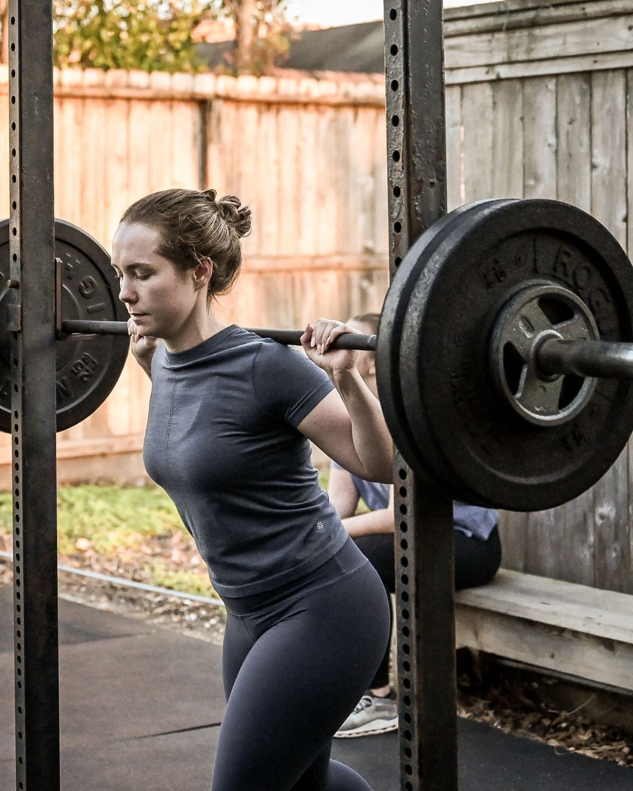 District H member squatting at the outdoor rack at the Houston Heights gym on Studewood Street